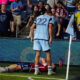 Zorhan Bassong stands of Paul Arriola after a confrontation in Sporting KC's MLS match vs FC Dallas.